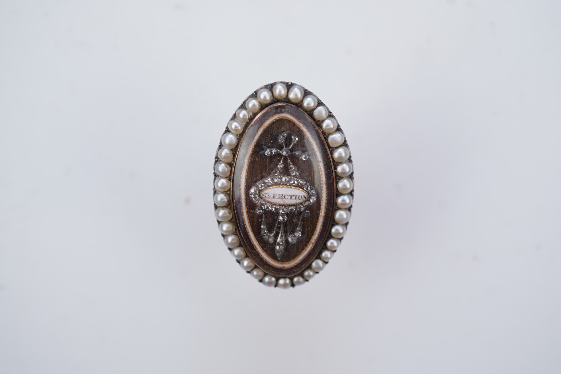 A fine George III seed pearl, enamel and diamond mourning ring, circa 1782